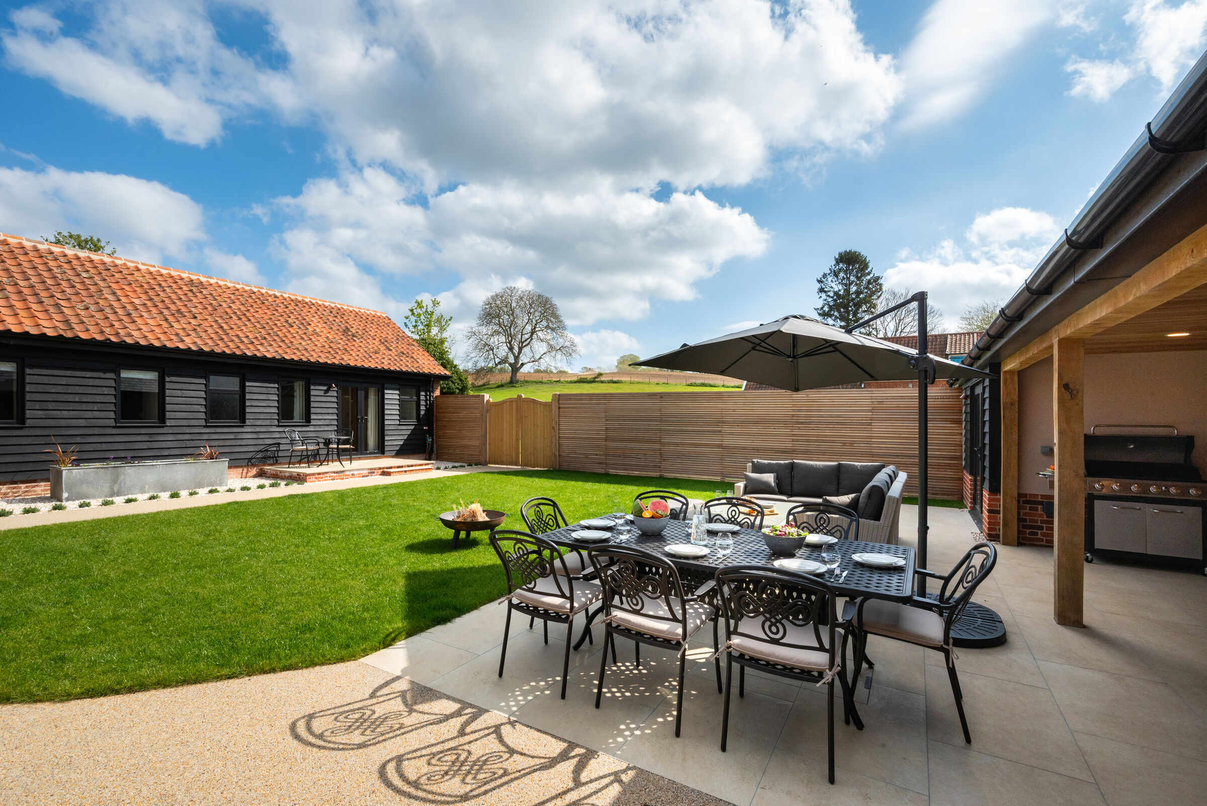 South-facing patio with outdoor dining and BBQ